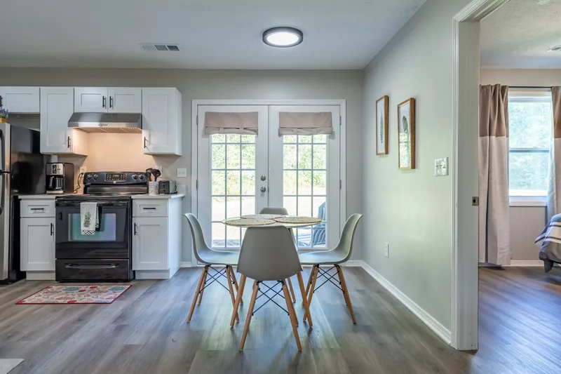 Kitchen with white shaker cabinets and dining area